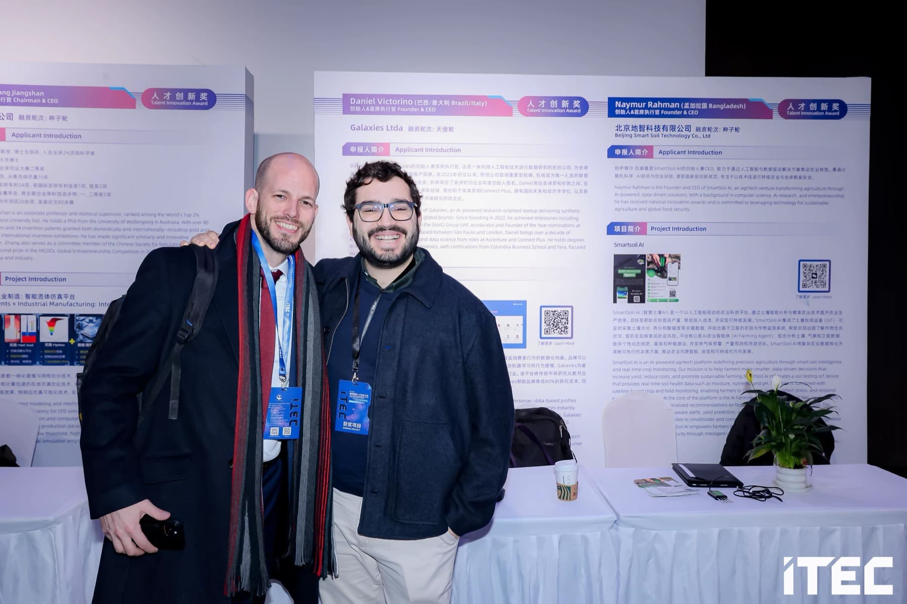 Two international founders beside their Talent Innovation Award project boards at the 13th ITEC in Beijing